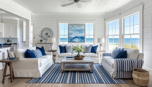 Airy living room, ocean view, white sofas, blue accents, light wood floor