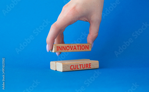 INNOVATION CULTURE symbol. Concept word INNOVATION CULTURE on wooden blocks. Businessman hand. Beautiful blue background. Business and INNOVATION CULTURE concept. Copy space