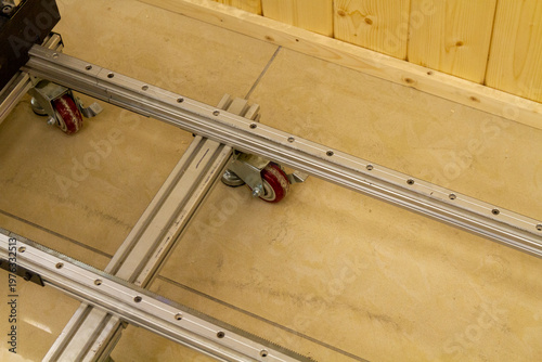 This item is a industrial castor wheel assembly mounted on an aluminum extrusion profile, commonly used in machinery frames or workstations. Industrial