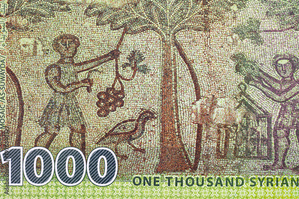 Naklejka premium 1000 Pounds of Syria with the image of a mosaic of grape harvest in the Roman ruins of As-Suwayda and olive branches. Money of Syria.