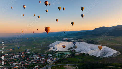 Hot air balloons and Natural travertine pools at sunrise in Pamukkale, 