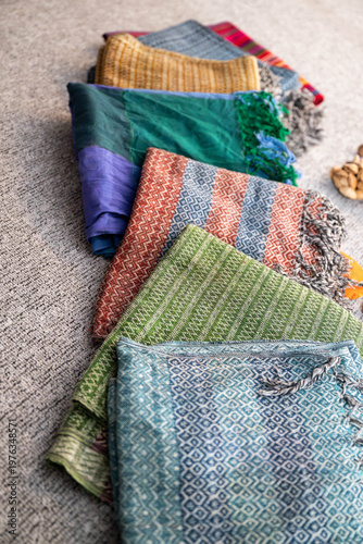 Rebozo massage and sound healing setup with Tibetan singing bowls, candles, yoga mats and traditional textiles, creating a calming wellness and holistic therapy atmosphere.
