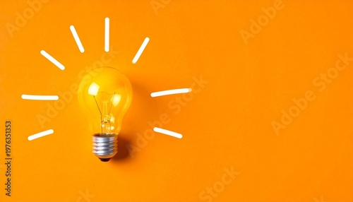 Yellow light bulb orange background radiating lines creative idea