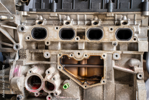 Εκτύπωση καμβά Close view of a disassembled car engine block with open intake ports, mounting holes, and exposed internal passages during mechanical repair