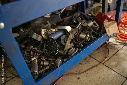 Εκτύπωση καμβά Container with used automotive parts including gears, chains and mechanical components stored in workshop during repair or replacement