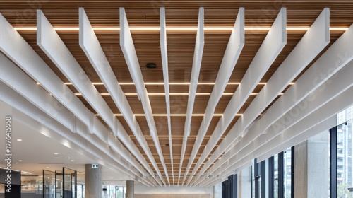 Closeup of acoustic ceiling baffles installed in a hospital corridor focusing on textured materials that minimize sound reflection while surrounding areas stay softly out of focus.
