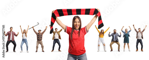 Happy young woman cheering with a scarf in front of a group of supporters