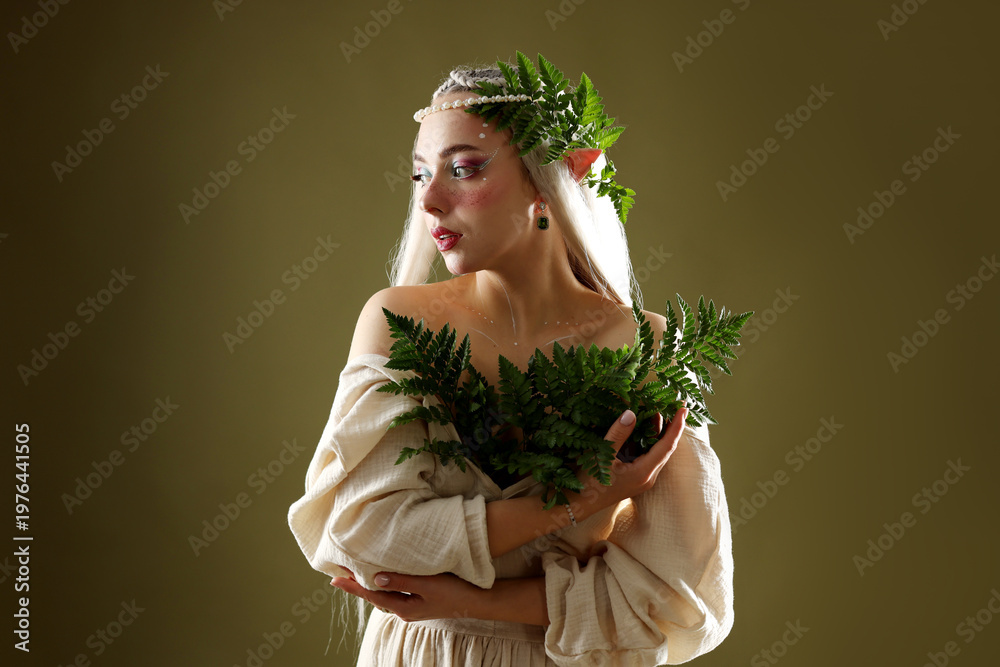 Obraz premium Beautiful elf girl with floral decor on dark olive background