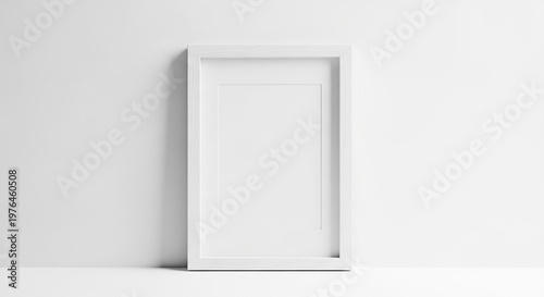 A minimalist white wooden frame rests on a clean white surface with soft shadows, offering a blank canvas for modern interior design art, clean, photo, isolated