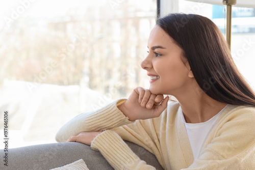 Young woman looking out win...
