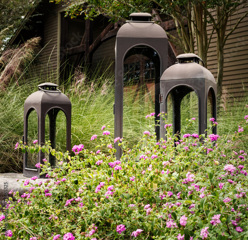 large lanterns in a garden of flowers