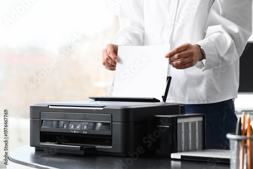 Businesswoman using printer...