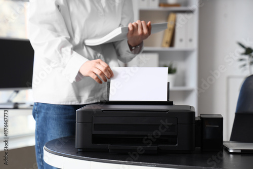 Businesswoman using printer...