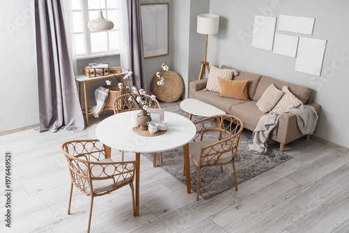 Interior of dining room with table, sofa and lamps