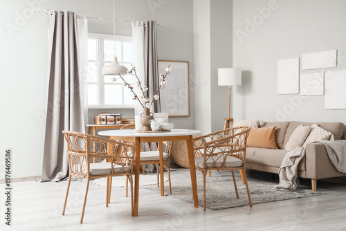 Interior of dining room with table, sofa and lamps