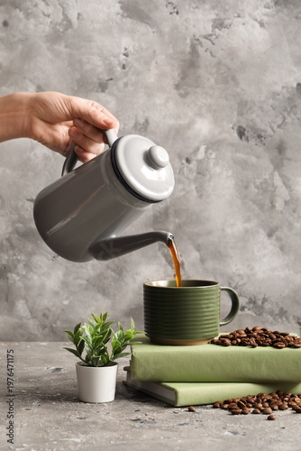 Woman pouring coffee into c...