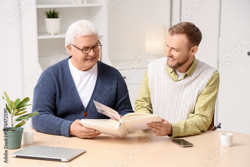 Senior man and his son with...