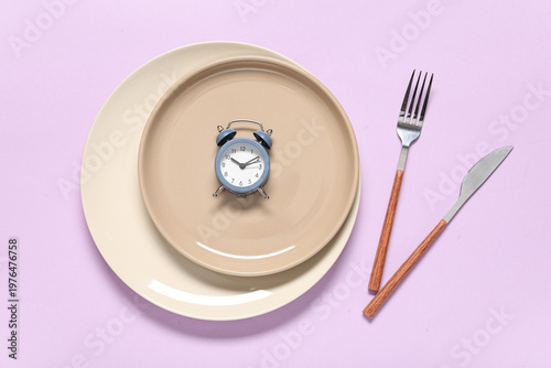 Plate with cutlery and alar...