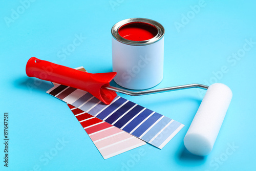 Roller with can of red pain...