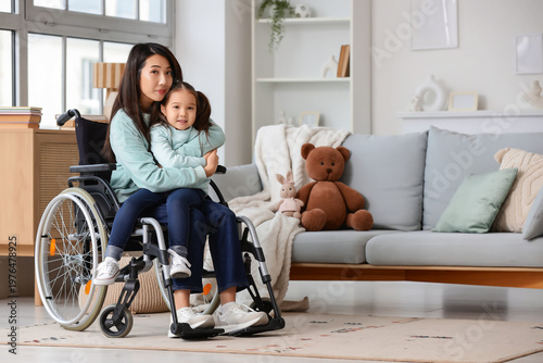 Young Asian mother in wheel...