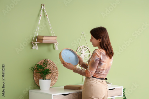 Young woman with wall clock...