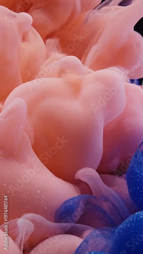 Pink and dark blue ink clouds swirling underwater with glitter, abstract fluid motion, slow motion movement of liquid colors, soft ethereal background, aesthetic artistic expression.