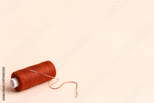 Brown sewing thread with ne...