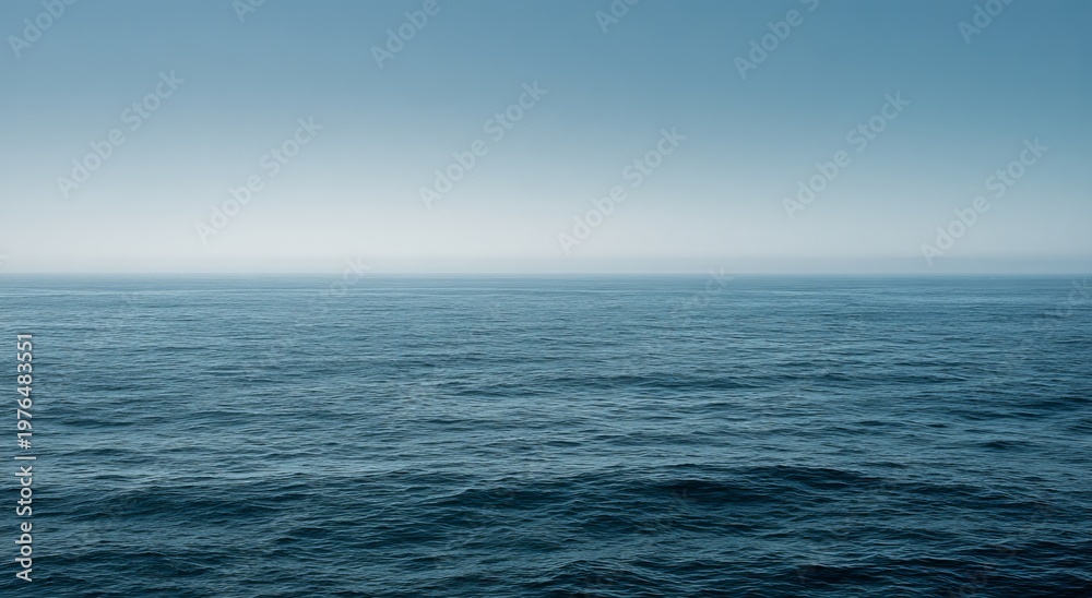 Naklejka premium Serene Ocean Vista - Calm Waters Under a Clear Sky.
