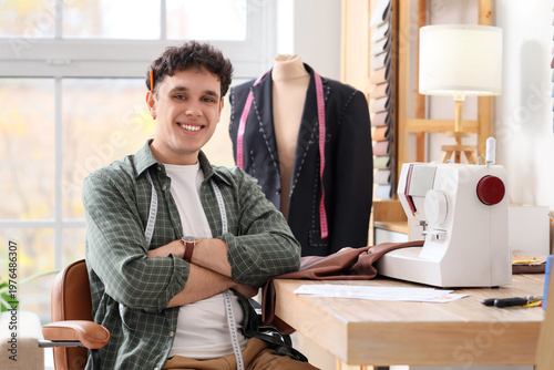 Young male tailor using sew...