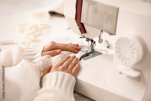 Female tailor's hands sewin...