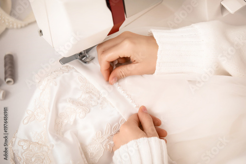 Female tailor's hands sewin...