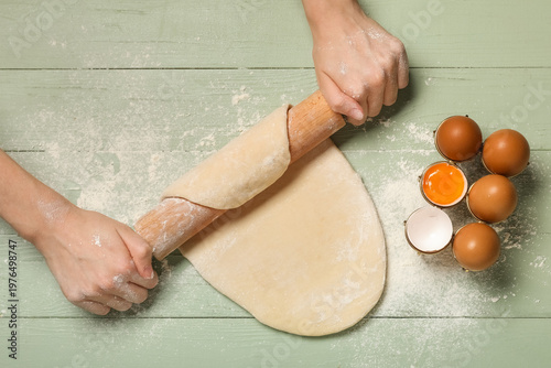 Woman rolling out dough on ...