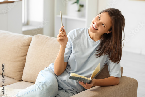 Young woman with notebook s...