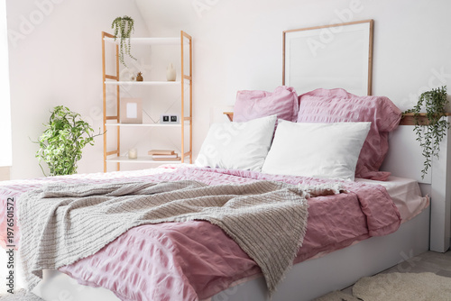 Bed with stylish pink beddi...