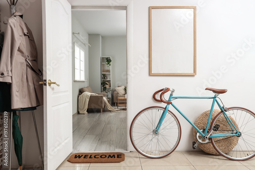 Bild auf Leinwand Interior of hallway with bicycle, blank frame and open door