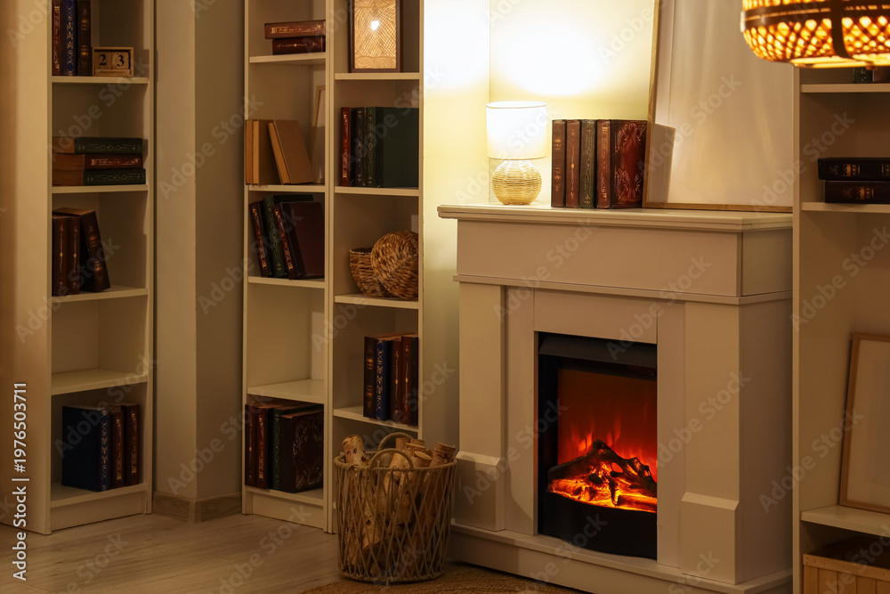 Fototapeta premium Interior of stylish room with fireplace and bookshelves at evening