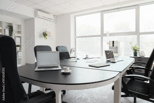Table with laptops, tablet ...
