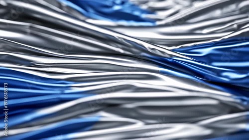 An abstract image of fabric rippling, with silver and blue flowing textures