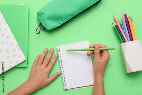 Child's hands writing down ...
