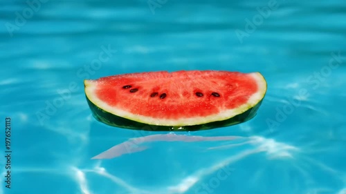 Fresh watermelon slice floating on clear blue swimming pool water