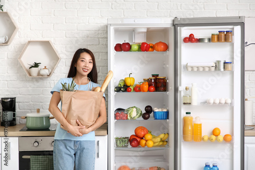 Young Asian woman holding p...