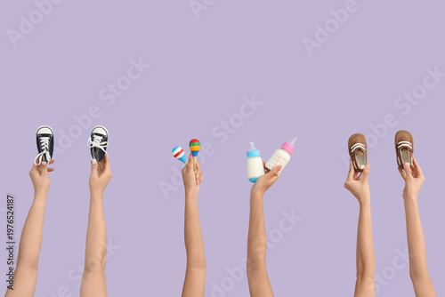 Female hands with baby shoe...