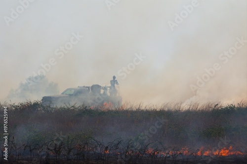 Valokuva Rural firefighters are battling a grass/brush fire in heavy smoke