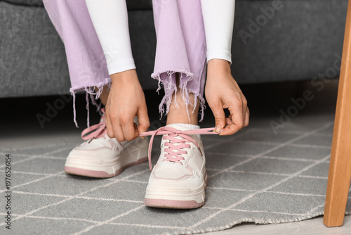 Woman in stylish sneakers a...