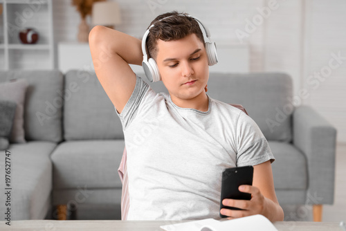 Teenage boy in headphones w...