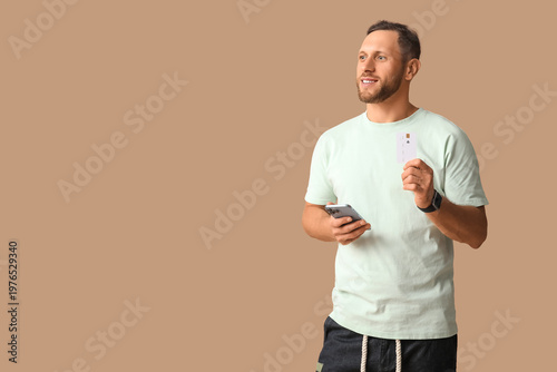 Stylish young man with mobi...
