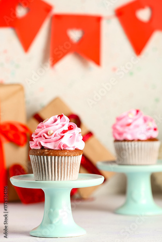 Stand with tasty cupcake fo...
