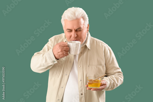 Mature man drinking tea wit...