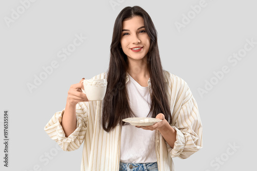 Pretty young woman with cup...