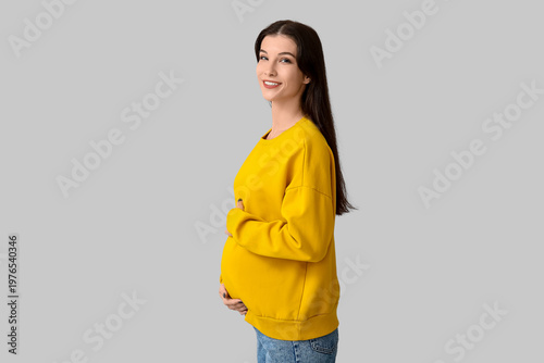 Happy pregnant woman on lig...
